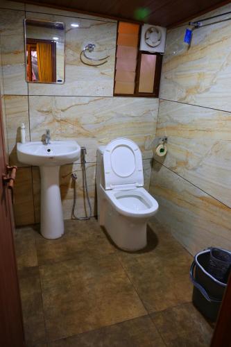 a bathroom with a toilet and a sink at Riverine Homestay Kochin in Cochin