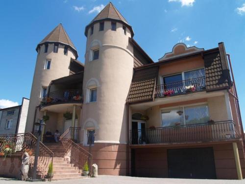 a building with two towers on top of it at Pokoje Gościnne Impresja Kadzidło in Kadzidło