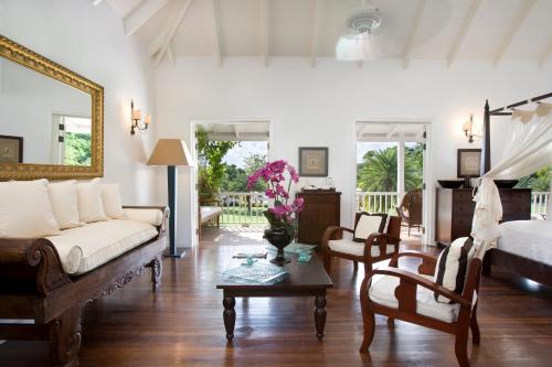 a living room with a couch and a table at The Inn at English Harbour in English Harbour Town