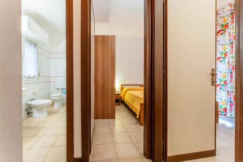 a bedroom with a bed and a bathroom at Giannella Beach Residence Apartment in Giannella