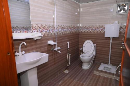 a bathroom with a toilet and a sink at Hotel Serina Inn in Kalar Goth