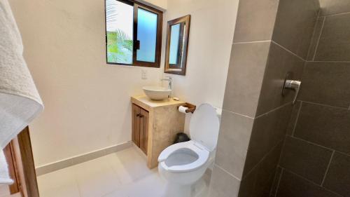 a bathroom with a toilet and a sink at Casa Puerto Viejo in Puerto Escondido
