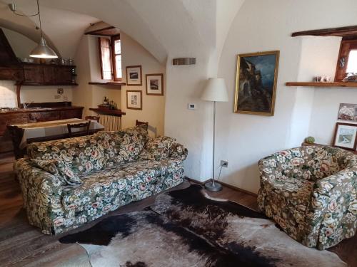 a living room with a couch and a chair at Baita del Plan in Pragelato