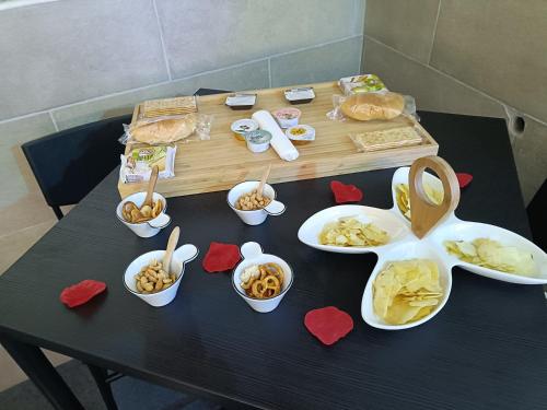 una mesa con platos de comida y tazones de comida en Valentine’s Suite, en Catania