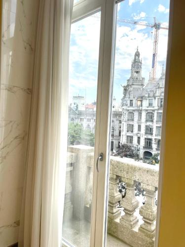 a sliding glass door with a view of a city at Hotel Universal in Porto