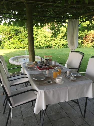 a table with plates of food on top at B&B Pension Marina in Rüttenen  