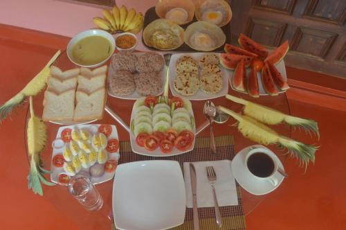 a table topped with lots of different types of food at Amazon Cabanas in Tissamaharama