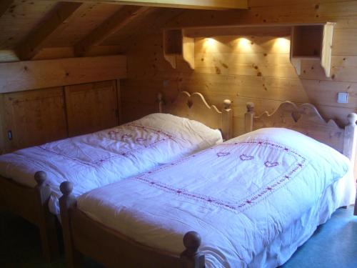 a bedroom with a bed in a wooden room at Chalet Le Grand-Bornand, 7 pièces, 13 personnes - FR-1-467-31 in Le Grand-Bornand
