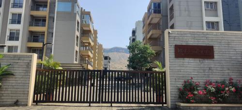 a gate in front of a building with some flowers at NASHVILLE - Apartment with Modern Amenities in Igatpuri
