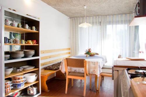 a kitchen with a table and a dining room at Apartment House Anton with free parking in Bovec