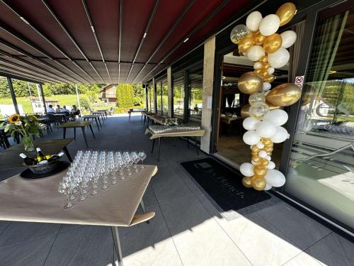 a group of wine glasses and balloons on a patio at Hôtel Restaurant & Spa Les Planets in Les Rasses