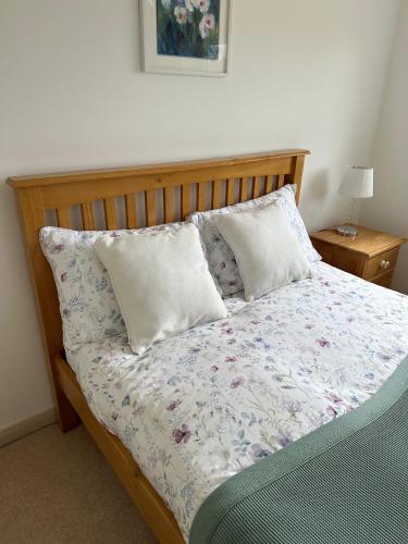 a bed with two pillows on it in a bedroom at Immaculate and Quiet Double Room - Great for Business and Travel Guests in Thorpe Saint Andrew