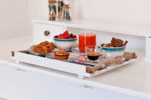 a tray of breakfast foods and drinks on a table at Vittoria Luxury House in Lecce