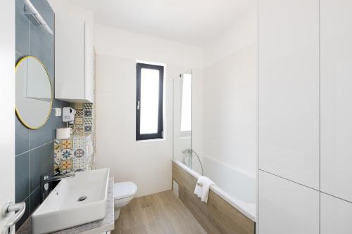 a bathroom with a sink and a mirror at Citadel Apartments in Timişoara
