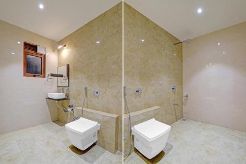 a bathroom with a shower and a toilet and a sink at Ratna Vilas Palace in Rajkot