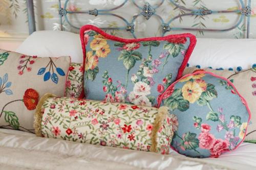 a couch with several pillows on it at The Dial House in Reepham