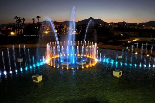 a fountain with lights in the water at night at Zagara Holiday House Palermo Cattedrale in Palermo