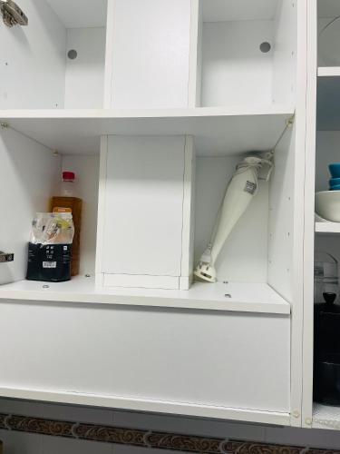 a white cupboard with a white object in it at Apartamento Conil Centro y Playa, descanso perfecto, con aire acondicionado y WIFI in Conil de la Frontera