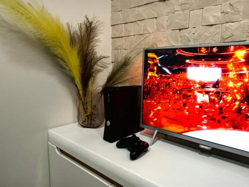 a computer monitor sitting on top of a desk at Red Brick House in Marijampolė