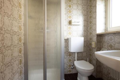 a bathroom with a toilet and a sink at Garni Juval in Tirolo