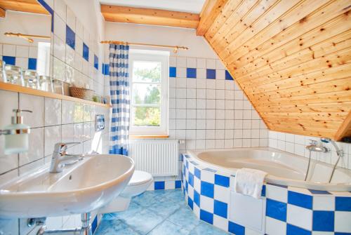 a bathroom with a tub and a toilet and a sink at Apartmán-Hotel Jítravský Dvorec in Rynoltice
