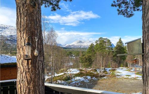 a view of a snowy mountain from a tree at Gorgeous Home In Bjorli With Wifi in Bjorli