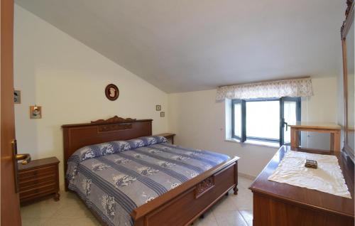 a bedroom with a bed and a dresser and a window at Amazing Home In Campodimele With House A Panoramic View in Campodimele