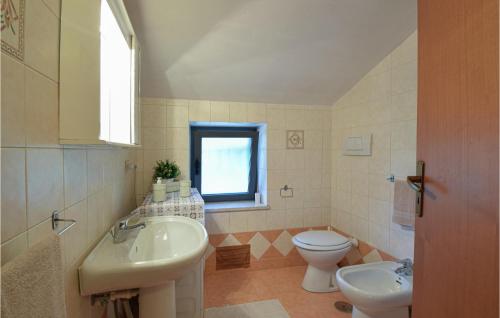 a bathroom with a sink and a toilet and a window at Amazing Home In Campodimele With House A Panoramic View in Campodimele