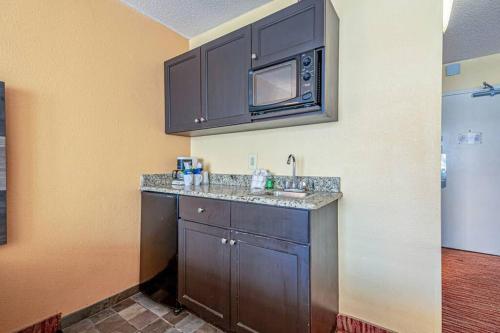 a kitchen with a sink and a microwave at Renovated Condo at Landmark Resort, Waterpark View in Myrtle Beach