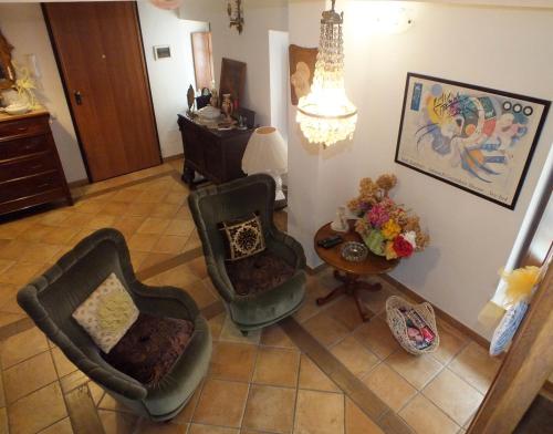 an overhead view of a living room with two chairs and a table at La Chicca in Carrara