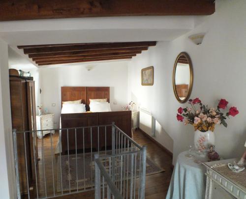 a bedroom with a bed and a table with flowers at La Chicca in Carrara