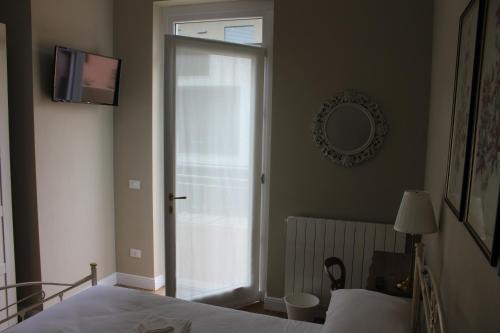 a bedroom with a bed and a sliding glass door at Casa Aydée in Bergamo