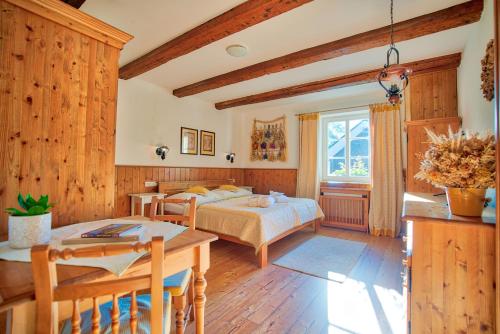 a bedroom with a bed and a table at Apartmán-Hotel Jítravský Dvorec in Rynoltice