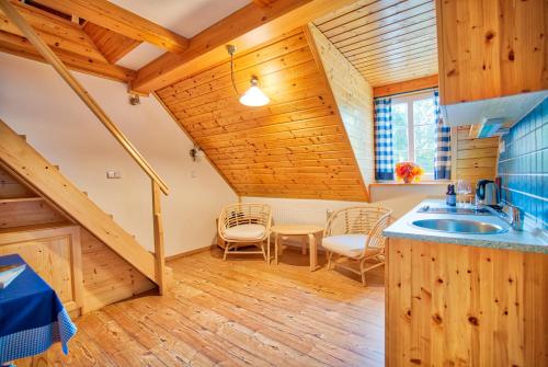 a kitchen with a sink and a table at Apartmán-Hotel Jítravský Dvorec in Rynoltice