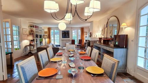une salle à manger avec une longue table et des chaises dans l'établissement Charmante villa de plain pied à proximité de la plage, à La Couarde-sur-Mer