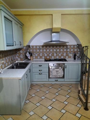 a kitchen with a sink and a stove at Casa Santa Maria in Frosolone