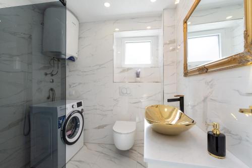 a bathroom with a washing machine and a sink at LA MARLENA in Benkovac