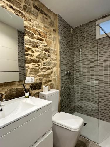 a bathroom with a white toilet and a sink at Casa Bela I Apart Lux Santiago in Santiago de Compostela