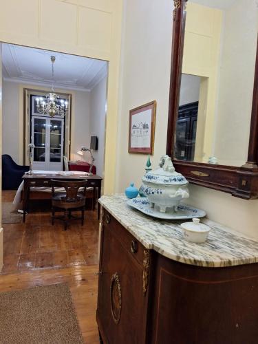 a room with a counter with a mirror and a table at Chiado apartments in Lisbon