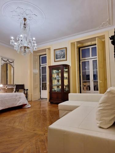 a large living room with a chandelier and a couch at Chiado apartments in Lisbon