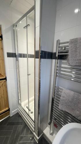 a glass shower in a bathroom with a sink at Quarry Cottage near Hawes, Yorkshire Dales, Pet free in Hawes