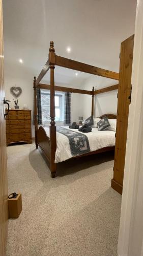 a bedroom with a wooden bed in a room at Quarry Cottage near Hawes, Yorkshire Dales, Pet free in Hawes