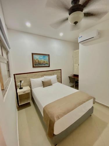 a bedroom with a bed and a ceiling fan at Hotel La Magdalena in Cartagena de Indias