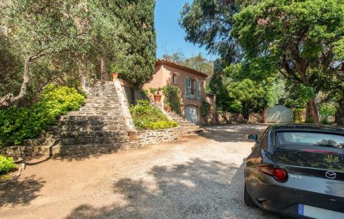 a car parked in front of a house at Villa la Malpagne, 400m2 les pieds dans l'eau in Rayol-Canadel-sur-Mer