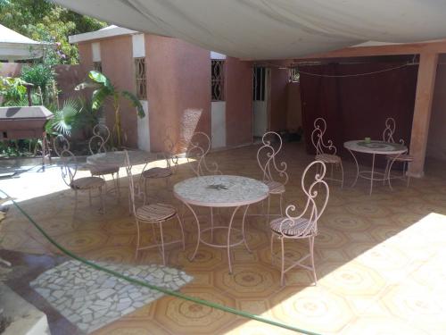 a group of tables and chairs on a patio at Auberge Triskell in Nouakchott