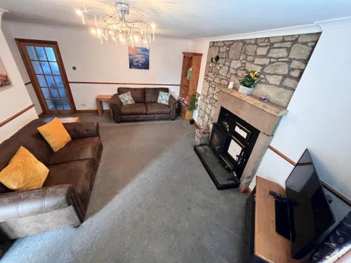 an overhead view of a living room with a fireplace at 2 Swinton Mill Farm Cottage in Swinton