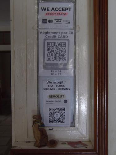a refrigerator with a lot of signs on it at Auberge Triskell in Nouakchott
