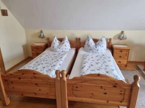 two twin beds in a room with wooden furniture at 2 Zimmer Wohnung in Thermennähe für 4 Personen in Bad Waltersdorf