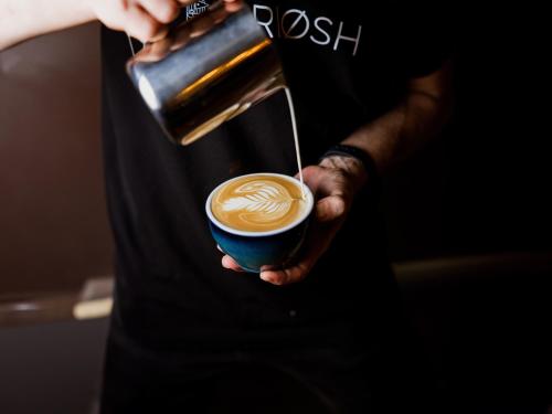 a person is holding a cup of coffee at Onyx Luxury Budapest in Budapest