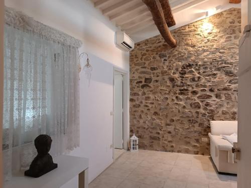 a bathroom with a stone wall with a statue on a counter at Il bosco sul Tevere Guest house in Perugia